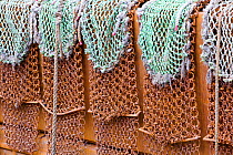 Scallop dredging nets on the side of a trawler in Kirkudbright harbour,  Scotland, April.