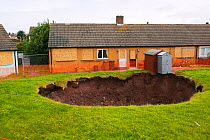 Sinkhole  in a back garden in Egremont Cumbria as a result of mining subsidence when an old mine shaft opened up, England, UK. June 2005