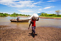 Food ferried across a river near Phalombe after the bridge was washed away. Malawi, March 2015.