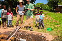 Medecins sans Frontieres  volunteer,  Makhanga pumping out a ground water drinking well that has been contaminated by polluted flood water after the January 2015 floods. Malawi, March 2015.
