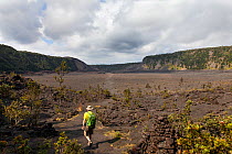 Hiker crossing the Kilauea Iki Crater, Hawaii Volcanoes National Park, Hawaii. Model released. December 2016.