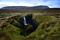 Hull Pot, Horton in Ribblesdale, Yorkshire, England, UK, January. Hull Pot is a collapsed cave in Carboniferous age limestone. In wet conditions a stream flows into the pot and continues its journey i...