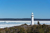 King's Cove lighthouse, with unseasonal sea ice in background, Bonavista Peninsula, Newfoundland, Canada, May 2017.