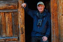 Photographer Staffan Widstrand,  Managing Director of Wild Wonders of China, standing in front of a hiker's cabin at small camp, near the glacier lake at  Mount Bawu Bameng, in the Meili Snow Mountain...