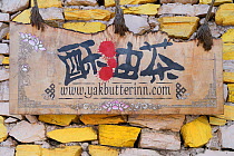 Guesthouse sign, in Upper Yubeng village, in the Meili Snow Mountain National park, Yunnan China. October.