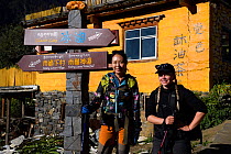 Wild Wonders of China Team members Zhang Qian and Lisa Widstrand, in Upper Yubeng village, in the Meili Snow Mountain National park, Yunnan, China. October 2017.