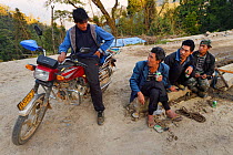 Men gathering in Xiang Bai Lisu village, Tongbiguan Nature Reserve, Dehong prefecture, Yunnan province, China, May 2017.