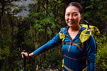 Zhang Qian, team member of Wild Wonders of China, hiking in the Temperate cloud forest, near the glacier lake at  Mount Bawu Bameng, in the Meili Snow Mountain National park, Yunnan China. October 201...
