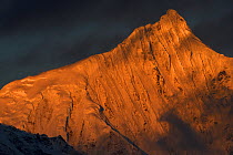 Meili Snow Mountain , 6740 m, a Sacred mountain for Tibetan Buddhists, yet unclimbed, Yunnan, China covered in sunset light. October 2017.