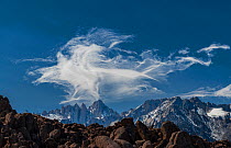 Lenticular cloud formation rising above the summit of Mount Whitney, eastern Sierra, California, USA, March 2018.