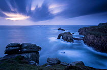 RF - Storm approaches Enys Dodnan Arch, the Armed Knight rock, and Longg Ships lighthouse at Land's End, Cornwall, UK. September 2016. (This image may be licensed either as rights managed or royalty f...
