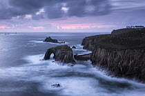 Enys Dodnan Arch, the Armed Knight rock and Longships lighthouse, Land's End, Cornwall, UK. October 2016.