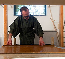 Benoit Dudognon, master paper maker, making Japanese washi paper, Camargue, Arles, France. February.