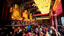 Buddhists worshiping inside Jogyesa Temple, Jongno-gu district, Seoul, South Korea, May 2016. Hellier