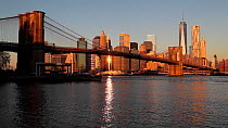 View of One World Trade Center and Lower Manhattan at sunset from across the Hudson River, with Brooklyn Bridge in the foreground, New York, Manhattan, United States of AmericaJune 2016. Hellier