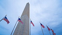 Timelapse from day to night of American flags flying around the Washington Monument, Washington DC, USAJune 2016. Hellier
