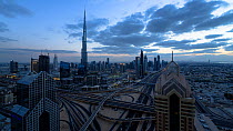 Wide angle timelapse from day to night of the Dubai Interchange, with the Burj Khalifa in the background, Dubai, United Arab Emirates, January 2017. Hellier