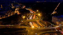 Timelapse from night to day of a busy road interchange near to the Bois de Boulogne, Paris, France, May 2016. Hellier