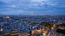 Timelapse of the sun setting over Paris and street lights coming on, with the Eiffel Tower in the background, Paris, France, May 2016. (This image may be licensed either as rights managed or royalty f...