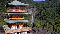 Aerial shot tracking towards Nachisan Seiganto-ji pagoda and Nachi Falls, Kumano Nachi Shrine, Wakayama, Japan, November 2017. Hellier