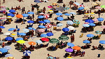 People sunbathing on Copacabana beach, Rio de Janeiro, Brazil, September 2016. Hellier