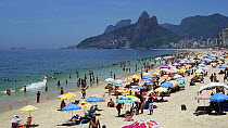 View of beachgoers on Ipanema Beach, with Dois Irmaos mountain in the background, Rio de Janeiro, Brazil, South AmericaSeptember 2016. Hellier