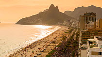 Timelapse of beachgoers on Ipanema Beach at sunset, with Dois Irmaos mountain in the background, Rio de Janeiro, Brazil, September 2016. Hellier