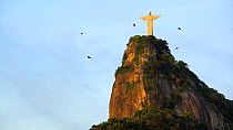 Black vultures (Coragyps atratus) soaring past the statue of the Cristo Redentor on Corcovado mountain, Rio de Janeiro, Brazil, September 2016. Hellier