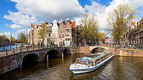 Timelapse of boats passing under the bridge on the corner of Keizersgracht and Leidesegracht and turning, Amsterdam, Netherlands, April 2017. Hellier