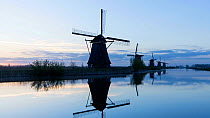 Timelapse of sun rising behind a row of windmills, Kinderdijk UNESCO World Heritage Site, Netherlands, April 2017. Hellier