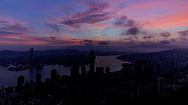 Timelapse of the sun rising over Hong Kong Central and Victoria Harbour, seen from Victoria Peak, Hong Kong, China, June 2017. Hellier