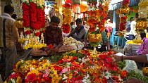 Man threading flowers in Krishna Rajendra flower market, Bangalore, Karnataka, India, January 2018. Hellier