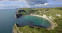 Aerial shot tracking over Lulworth Cove, Dorset, England, UK, May 2017. Hellier
