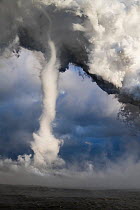 Lava entering the ocean forming, steam, laze (a dangerous acidic steam formed when lava meets saltwater) and a waterspout. The lava originated from fissure 8, Kilauea volcano. Kapoho, Puna District, H...