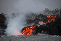A'a lava entering the ocean, emanating from Fissure 8 of the Kilauea Volcano, Cape Kumukahi, Kapoho, Puna District, Hawaii. June 2018.