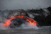 A'a lava entering the ocean, emanating from Fissure 8 of the Kilauea Volcano, Cape Kumukahi, Kapoho, Puna District, Hawaii. June 2018.
