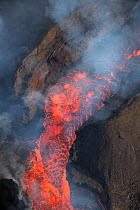 Lava erupting from fissure 8 of the Kilauea Volcano, boiling out of cinder cone.  East rift zone in Leilani Estates, near Pahoa, Puna District, Hawaii. June 2018.
