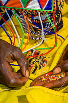 Maasai woman working on bead work, Maasai Village, Kenya. September 2006.