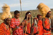 Maasai, young warriors, two with lion mane head dress. Maasai Village, Kenya. September 2006.