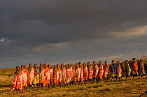 Maasai people singing at first light, Maasai village, Kenya. September 2006.