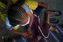 Girl with traditional hair braids / cornrows, Harar, Ethiopia. February 2008.
