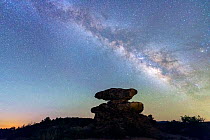 Balanced rock hoodoo in Echo Canyon silhouetted against the rising Milk Way. Chiricahua National Monument, Arizona, USA. April.