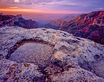 Saddle Mountain overlook (Saddle Mountain at left) at dawn with water filled  rim-rock in the foreground. Grand Canyon National Park, Arizona, USA.