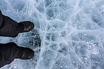 Photographer Sue Flood's feet standing on sea ice near Elephant Head, Union Glacier, Antarctica.