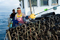 Fishermen preparing Giant isopod (Bathynomus doederleinii) traps aboard fishing boat. Suruga Bay, Shizuoka Prefecture, Honshu, Japan. April 2018.