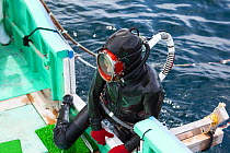 Ama diver climbing aboard boat after spending two hours collecting seafood. Futo Harbour, Izu Peninsula, Shizuoka Prefecture, Japan. June 2010.