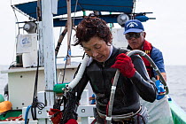 Ama diver back aboard boat after spending two hours collecting shellfish. Futo Harbour, Izu Peninsula, Shizuoka Prefecture, Japan. June 2010.