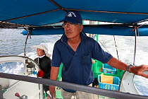 Ama diver team, husband and wife, traveling in boat to work at sea. Futo Harbour, Izu Peninsula, Shizuoka Prefecture, Japan. June 2010.