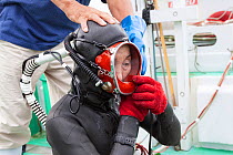Ama diver adjusting her mask and breathing hose before going into the ocean to work. Futo Harbour, Izu Peninsula, Shizuoka Prefecture, Japan. June 2010.