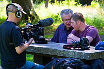 Photographers Oliver Hellowell and Ken Jenkins (Tennessee based photographer) being interviewed on film for the BBC programme The One Show. Balloch Castle, Loch Lomond, Scotland, UK. July 2018